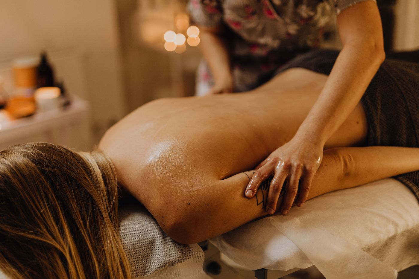 Back massage in a warm, softly lit treatment room